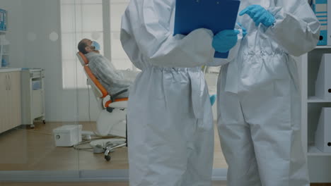 Professional-stomatologists-wearing-ppe-suits-at-oral-clinic