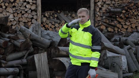 Exhausted-from-work-lumberjack.-Man-woodcutter.-Sawn-logs,-firewood-background.-Wood-harvesting