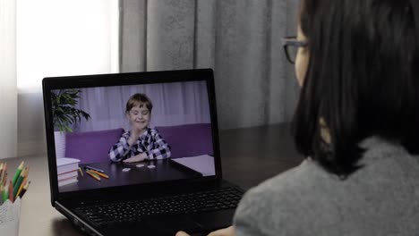 Woman-teacher-makes-video-call-on-laptop-with-children-pupil.-Distance-education