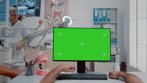 POV-of-assistant-working-with-green-screen-on-computer
