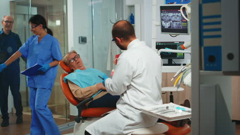 Dentista-Explicando-La-Cirugía-Utilizando-Un-Modelo-De-Yeso-De-La-Mandíbula
