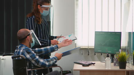Coworkers-with-masks-and-disability-working-in-new-normal-office