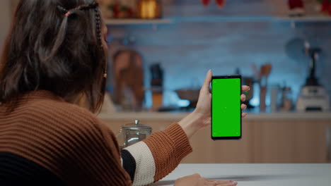 Caucasian-woman-holding-smartphone-with-green-screen