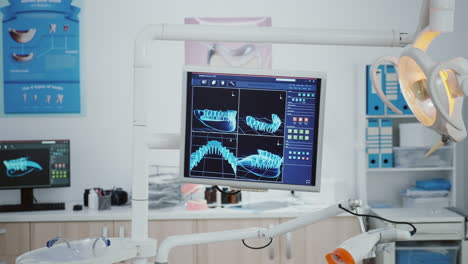 Close-up-of-monitor-with-tooth-radiography-images-on-it-i