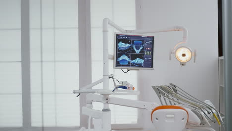 Close-up-of-medical-orthodontist-display-with-teeth-x-ray-images-on-it