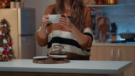 Woman-enjoying-cup-of-hot-tea-while-thinking-about-family
