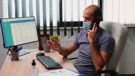 Worker-with-face-mask-talking-on-phone