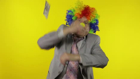 Elderly-clown-businessman-dancing,-celebrate.-Money-dollar-cash-falls-from-above