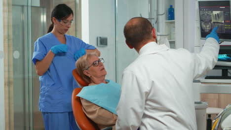 Nurse-putting-dental-bib-to-old-woman