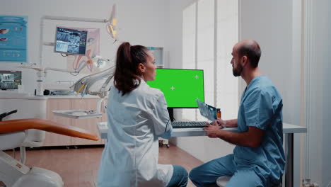 Dentistry-team-analyzing-teeth-x-ray-and-green-screen-on-monitor