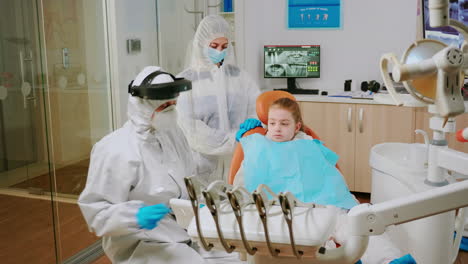 Child-with-ppe-suit-taking-care-of-dental-health-during-coronavirus-pandemic