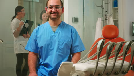 Portrait-of-smiling-man-nurse-in-dental-office