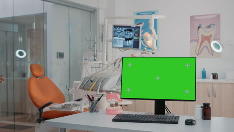 Dental-cabinet-with-horizontal-green-screen-on-monitor