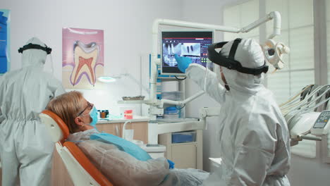 Orthodontist-in-special-equipment-pointing-on-digital-x-ray
