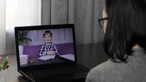 Woman-teacher-making-video-call-on-laptop-with-little-pupil.-Distance-education