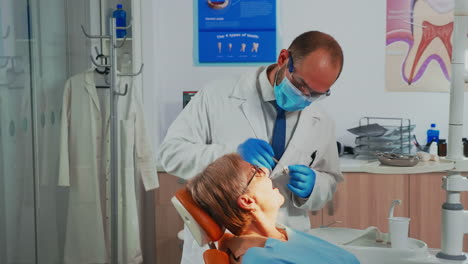 Orthodontist-examinating-patient-using-sterile-dental-tools