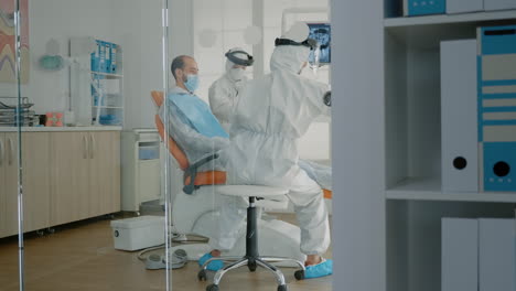 Orthodontists-and-patient-wearing-ppe-suits-in-oral-cabinet