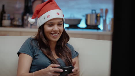 Person-with-santa-hat-winning-video-games-with-joystick