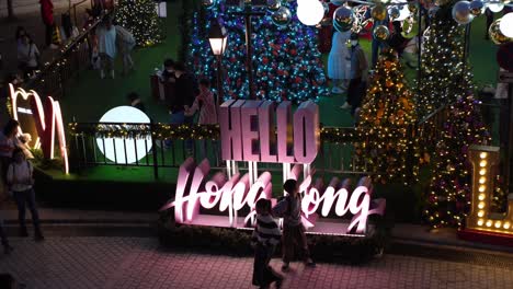 Children-being-entertained-by-the-Christmas-lights,-trees-and-neon-signs
