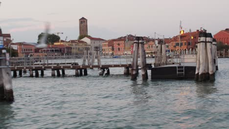 Entering-Murano-island-with-boat,-seagulls-fly-around