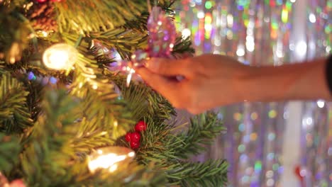 Hanging-pink-iridescent-hummingbird-decoration-on-Christmas-tree