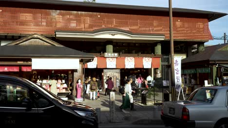 Outside-Entrance-View-To-Arashiyama-Station-WIth-People-And-Traffic-Going-Past