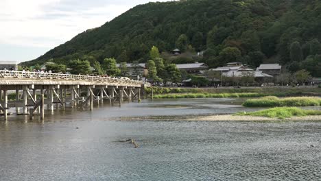 Katsura-River-With-Togetsukyo-Bridge-And-Forested-Western-Hills-of-Arashiyama-In-Background
