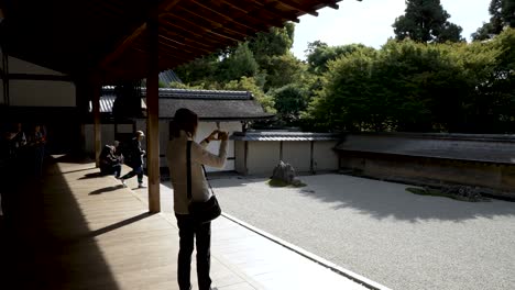 Tourist-Taking-Video-On-Smartphone-At-Ryoanji-Temple-Zen-Rock-Garden-From-Veranda