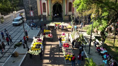Organization-of-a-group-of-people-assembling-a-giant-floral-structure-in-the-Cathedral-of-Iztapalapa,-south-of-the-CDMX,-day-of-the-dead---Drone-shot