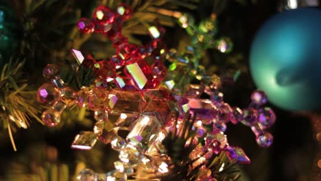 Multicolored-crystal-snowflake-ornament-on-decorated-christmast-tree