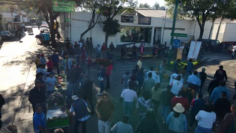 Static-aerial-view-of-the-procession-in-commemoration-of-the-Day-of-the-Dead-in-Iztapalapa,-CDMX,-Mexican-celebration