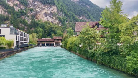 Interlaken-Switzerland-Immersive-Travel-Tourism-Mountainside-Valley-Resort-City,-Europe,-Walking,-Rainy-Day,-4K-|-Looking-Around,-Shaky,-Water,-River,-Lake,-Restaurant,-Flowers,-Mill,-Bridge,-Bench