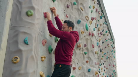 Joint-training-session-of-a-man-who-climbs-a-climbing-wall-without-insurance-outside