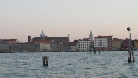 Beautiful-city-of-Venice-during-sunset,-view-from-moving-boat