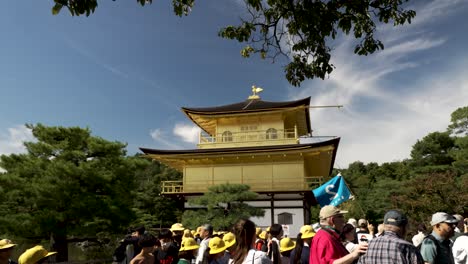 Tourists-walking-around-the-golden-pavilion-building-in-Kyoto