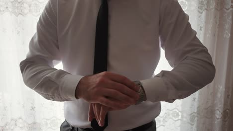 groom's-preparing-his-watch-at-home