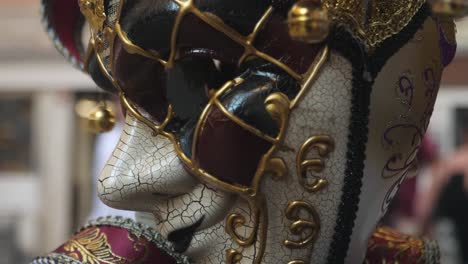 Detailed-close-up-of-Venezia-carnival-mask-with-city-street-in-background