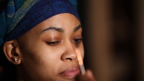 close-up-view-of-a-beautiful-African-American-woman-having-her-eye-brows-style-by-a-professional-make-up-artist-in-a-studio-space