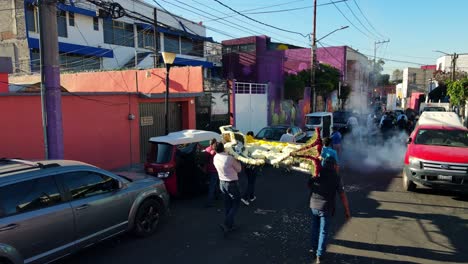 Establishing-of-a-Day-of-the-Dead-procession-in-Iztapalapa,-south-of-CDMX,-old-person-throwing-fireworks