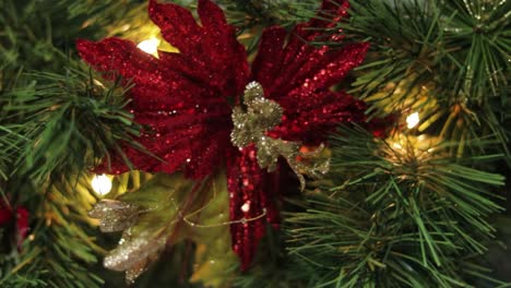 Christmas-poinsettia-decoration-with-glitter-in-pine-garland-needles