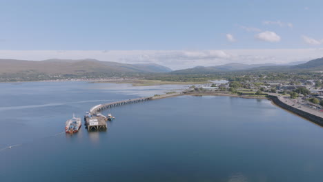 Fort-William-aerial-reveal-shot-above-Loch-Linnhe-near-old-pier-looking-north