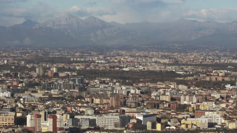 Alps-and-city-of-Milan,-contrast-between-nature-and-urban-territory
