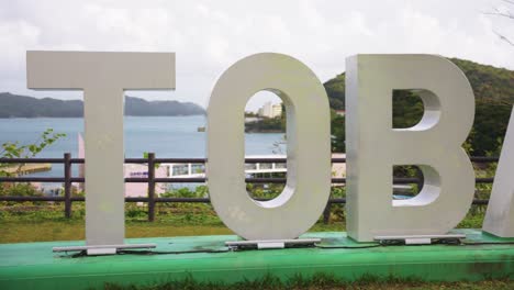 Panning-over-"I-Love-Toba"-Sign-with-Toba-seaside-and-Mikimoto-Pearl-Island-in-Distance