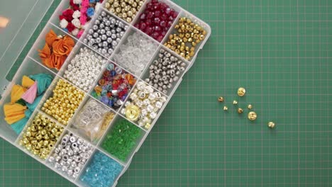 Opening-plastic-jewelry-organizer-box-with-beads-in-compartments