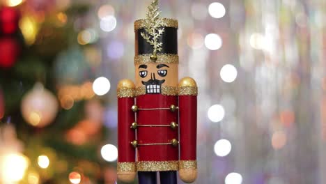 Toy-soldier-nutcracker-decoration-on-bokeh-christmas-lights-background