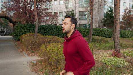 Young-European-man-running-exercising-outdoors-in-city-park