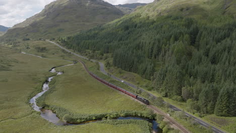 Jacobite-Express-Aerial-track-towards-Glenfinnan-Station-along-the-River-Fae