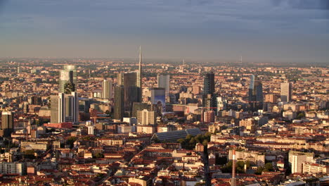 Milan-city-skyscrapers-during-sunset,-aerial-view