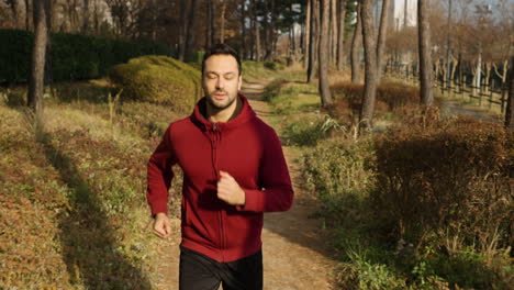 Man-Running-on-Trail-in-Autumn-Park---front-view