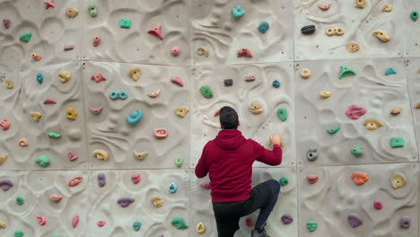 Free-climber-young-man-climbing-on-a-climbing-wall